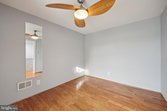 spare room with ceiling fan and hardwood / wood-style flooring