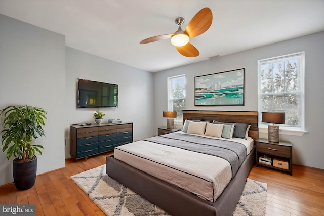 bedroom with ceiling fan and light hardwood / wood-style floors