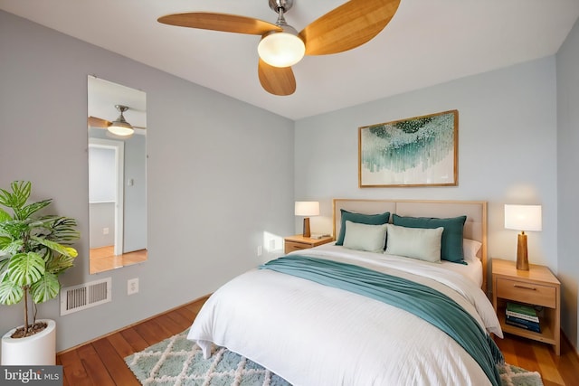 bedroom with ceiling fan and hardwood / wood-style flooring