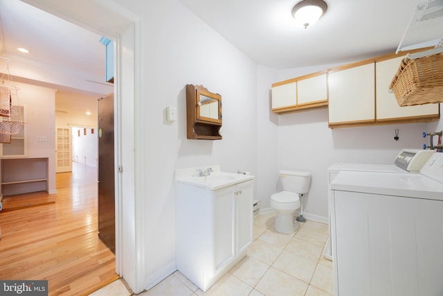 bathroom featuring hardwood / wood-style flooring, washer and dryer, vanity, and toilet