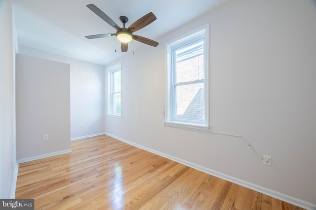 empty room featuring ceiling fan and light hardwood / wood-style floors