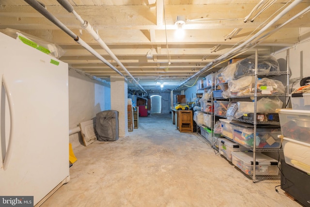 basement featuring white refrigerator