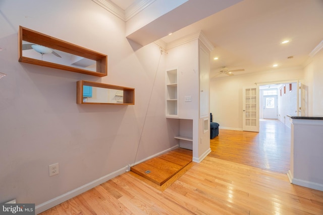 hall with crown molding and light hardwood / wood-style flooring