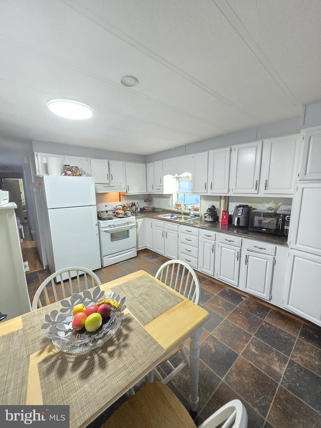 kitchen featuring white cabinets, sink, and white appliances