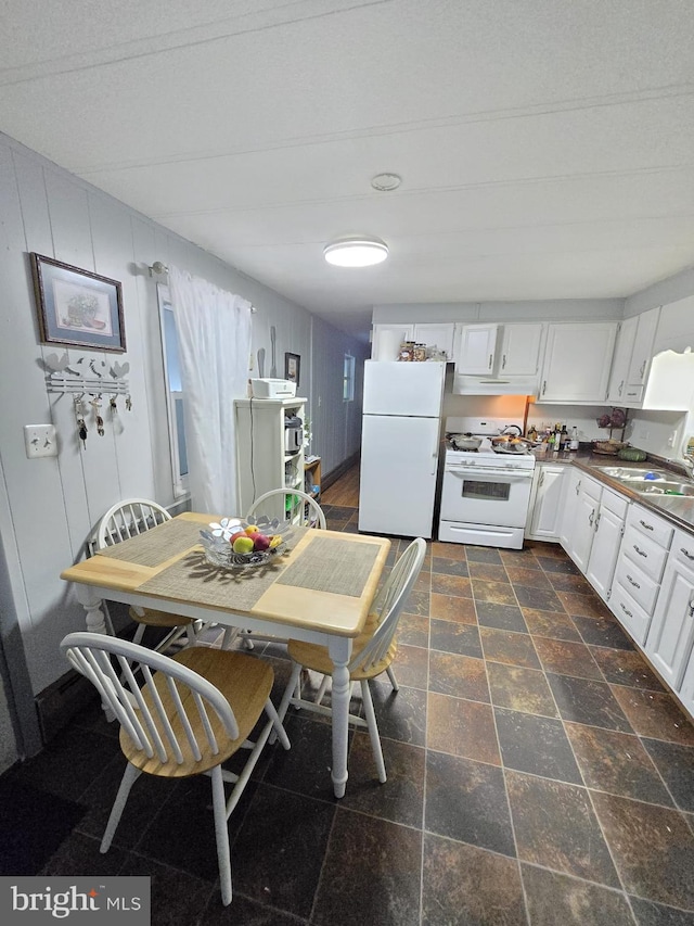 kitchen featuring a textured ceiling, white appliances, sink, and white cabinets