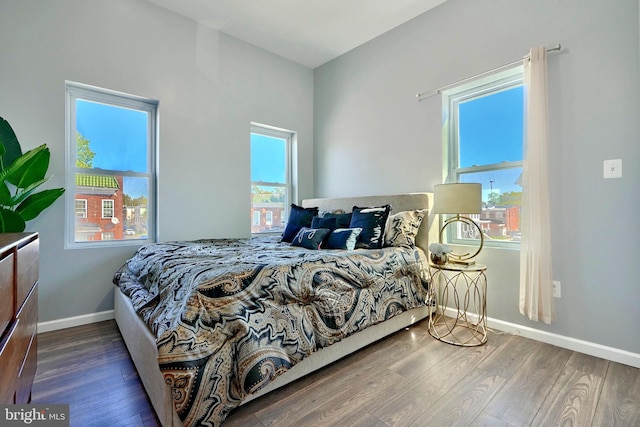 bedroom featuring dark hardwood / wood-style flooring and multiple windows