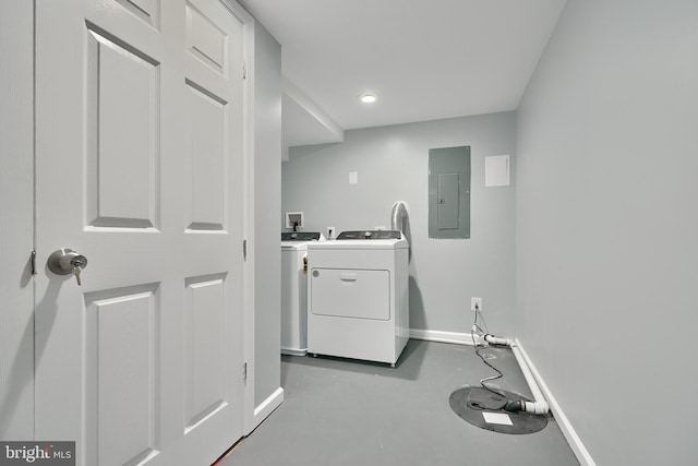 clothes washing area with separate washer and dryer and electric panel