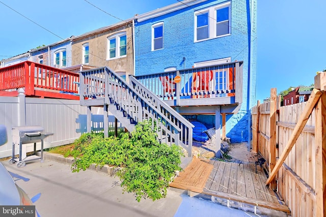 rear view of house with a wooden deck