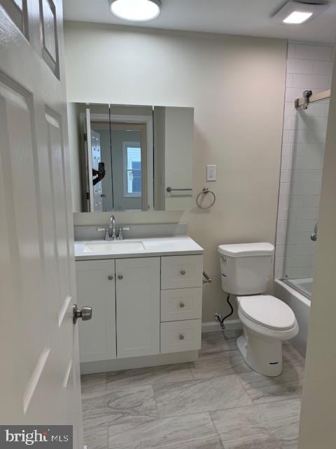 full bathroom featuring bath / shower combo with glass door, vanity, and toilet