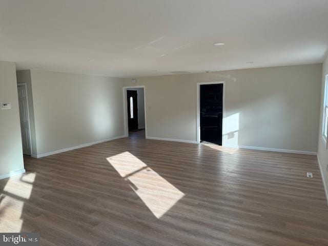 empty room with wood finished floors and baseboards