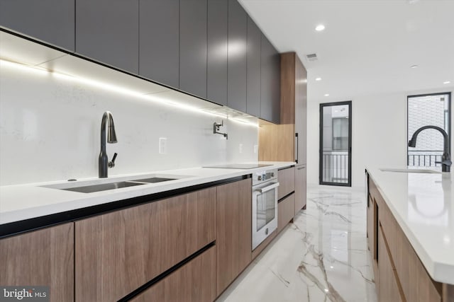 kitchen with backsplash, sink, oven, and stove