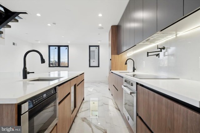 kitchen with exhaust hood, sink, and black appliances