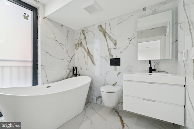 bathroom featuring a bathtub, vanity, and toilet