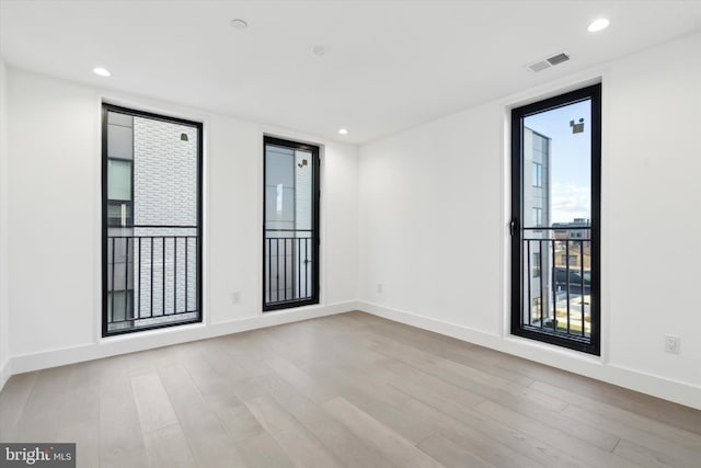 empty room with light hardwood / wood-style flooring