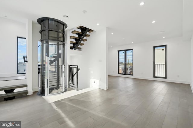 unfurnished living room featuring light wood-type flooring