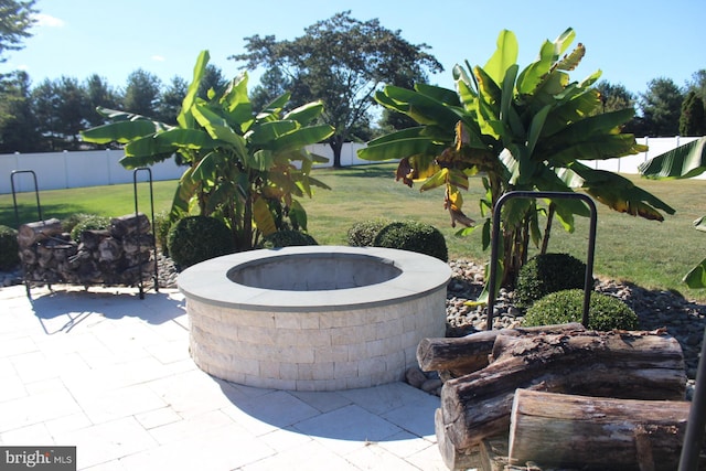 view of patio / terrace featuring an outdoor fire pit and fence