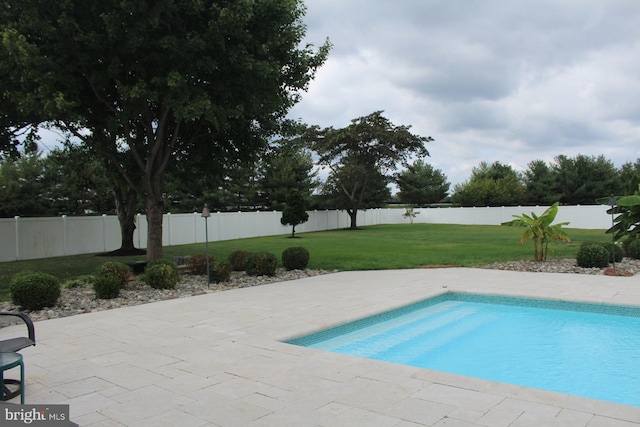 view of pool with a yard, a fenced backyard, a fenced in pool, and a patio