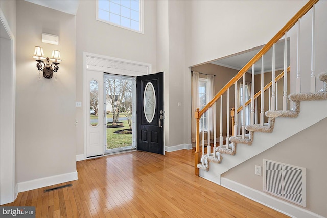 foyer entrance with plenty of natural light, wood-type flooring, and visible vents