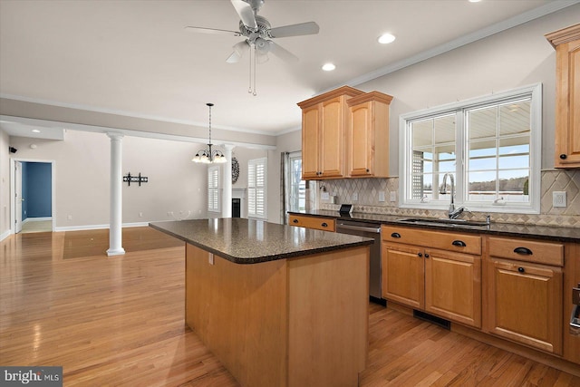 kitchen featuring a center island, decorative columns, backsplash, a sink, and dishwasher