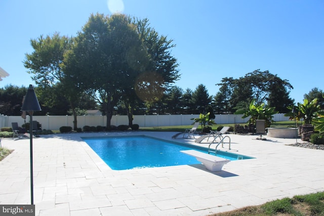 view of pool with a diving board, a patio area, a fenced backyard, and a fenced in pool