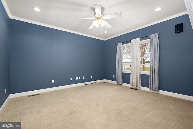 unfurnished room with ornamental molding, carpet flooring, visible vents, and baseboards