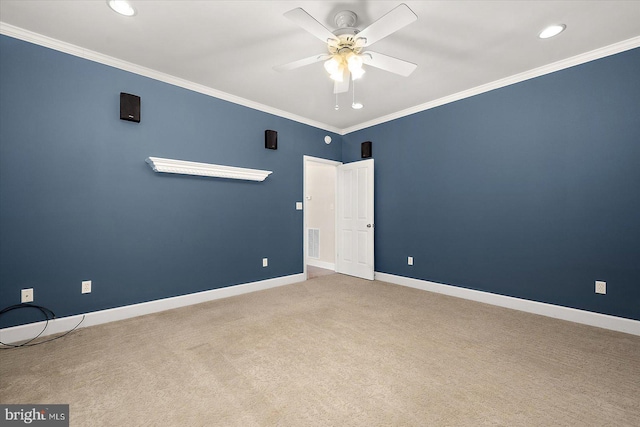 spare room featuring ornamental molding, carpet, visible vents, and baseboards