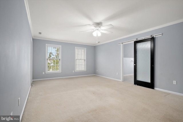 spare room with carpet, crown molding, visible vents, ceiling fan, and baseboards