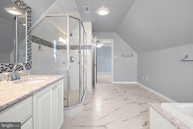 bathroom with marble finish floor, lofted ceiling, a stall shower, vanity, and baseboards