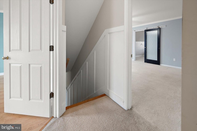 staircase featuring carpet, ornamental molding, and baseboards