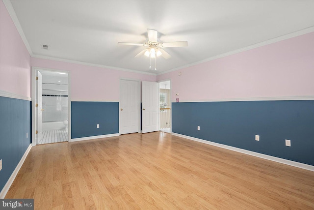 interior space featuring baseboards, visible vents, ensuite bathroom, crown molding, and light wood-style floors