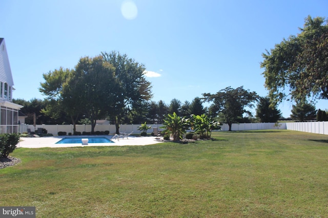 view of yard featuring a patio, a fenced backyard, and a fenced in pool