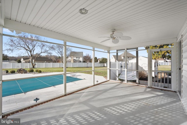 unfurnished sunroom featuring a residential view and a healthy amount of sunlight