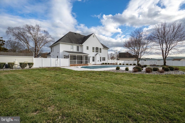 rear view of property with a patio, a fenced backyard, a sunroom, a lawn, and a fenced in pool