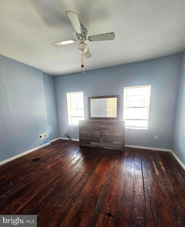 spare room featuring dark hardwood / wood-style floors and ceiling fan