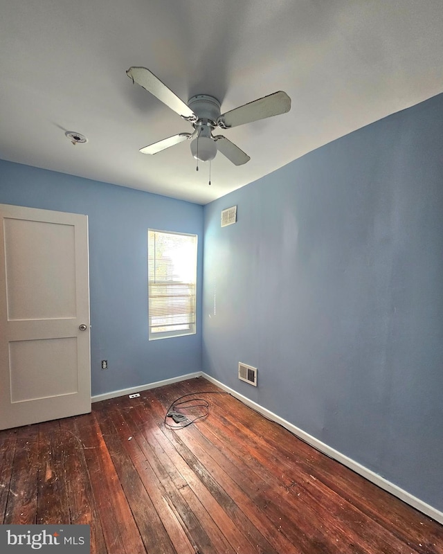 unfurnished room with dark wood-type flooring and ceiling fan