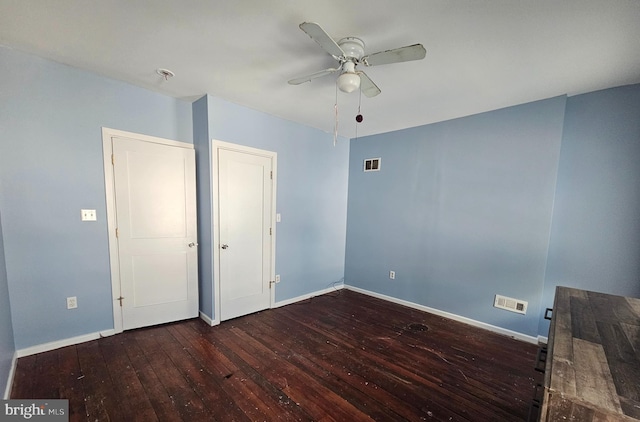 empty room featuring dark hardwood / wood-style floors and ceiling fan