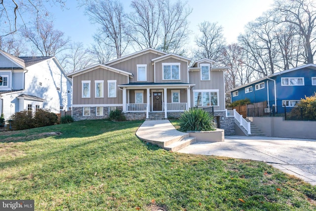 view of front of house featuring covered porch and a front lawn