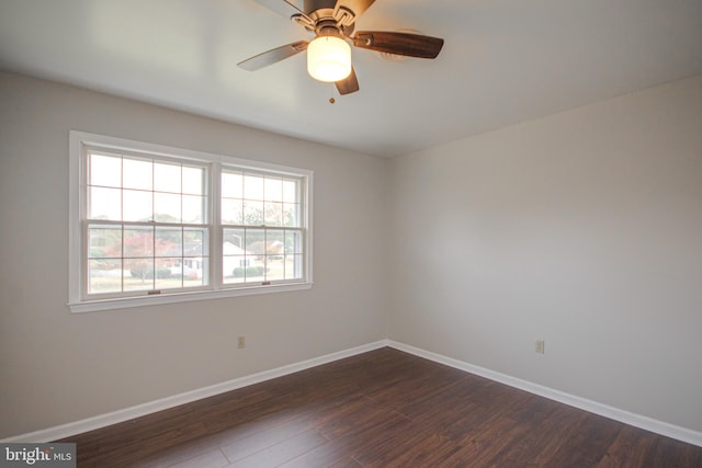 empty room featuring ceiling fan and dark hardwood / wood-style flooring