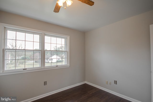 spare room featuring dark hardwood / wood-style flooring and ceiling fan