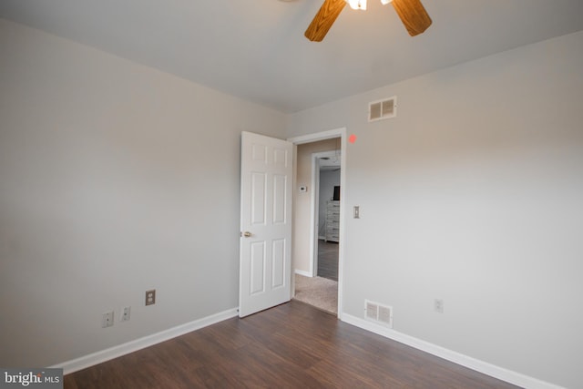 spare room with ceiling fan and dark wood-type flooring