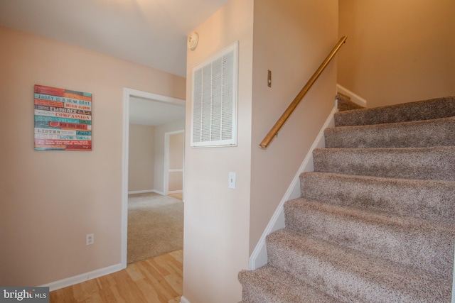 stairs featuring wood-type flooring