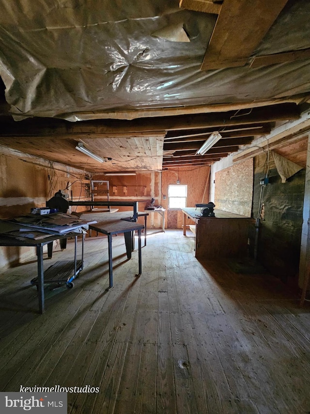 playroom with wooden walls and hardwood / wood-style floors