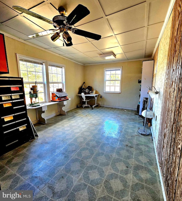 miscellaneous room featuring a drop ceiling, a healthy amount of sunlight, and ceiling fan