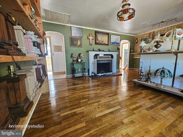 living room featuring crown molding and wood-type flooring