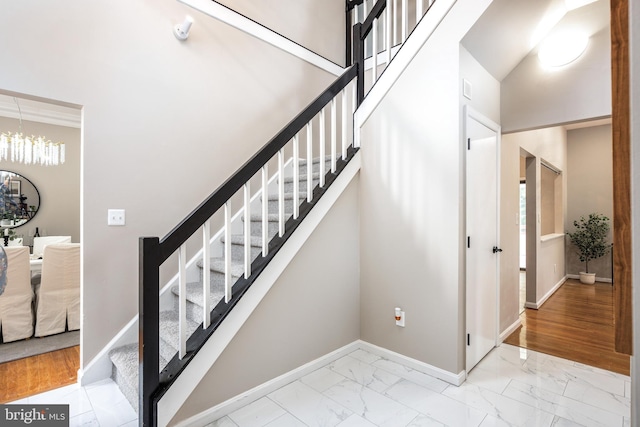 staircase featuring a notable chandelier and wood-type flooring