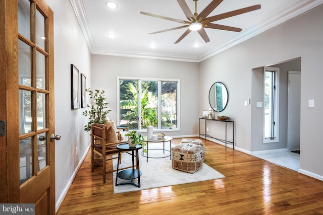 living area featuring french doors, crown molding, hardwood / wood-style flooring, and ceiling fan