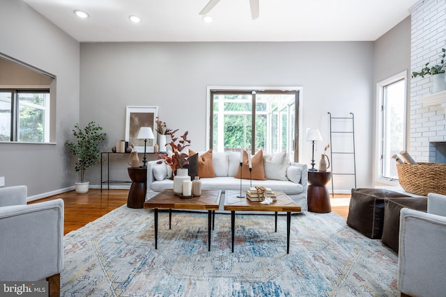 living room with hardwood / wood-style flooring and ceiling fan