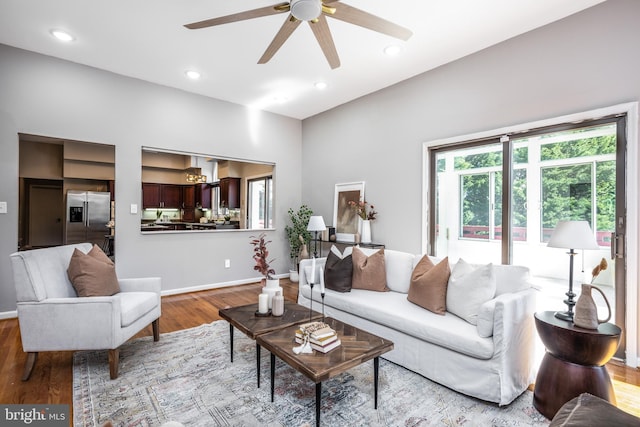 living room featuring ceiling fan and light hardwood / wood-style flooring