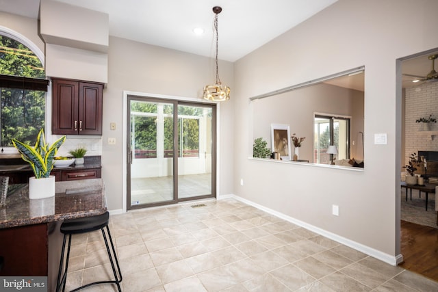 doorway to outside featuring light hardwood / wood-style flooring and ceiling fan with notable chandelier