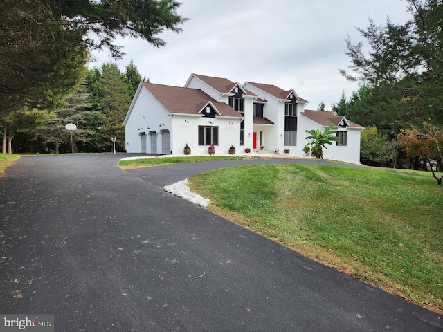 view of front of property featuring a front lawn and a garage